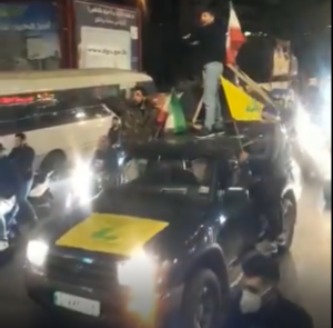 Convoy waving Iranian and Hezbollah flags